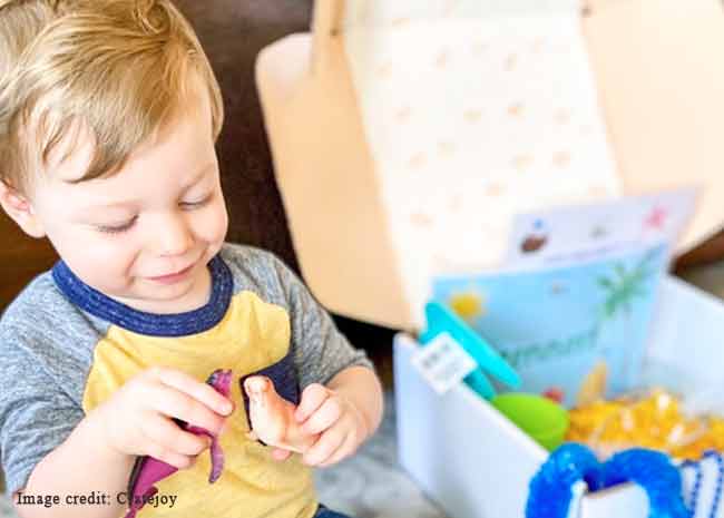 Toddler playing with toys he got out of his Montessori subscription box.