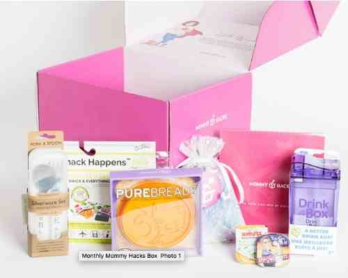 An open pink box with various mommy products placed in front of it.