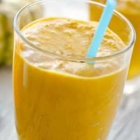 Pumpkin lactation smoothie with blue straw.