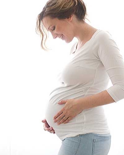 Pregnant woman holding her bump.