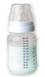 Blue colored breast milk in a baby bottle.
