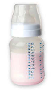 Pink colored breast milk inside of a baby bottle.